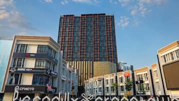 A commercial area with a prominent building, storefronts, and a decorative sign.
