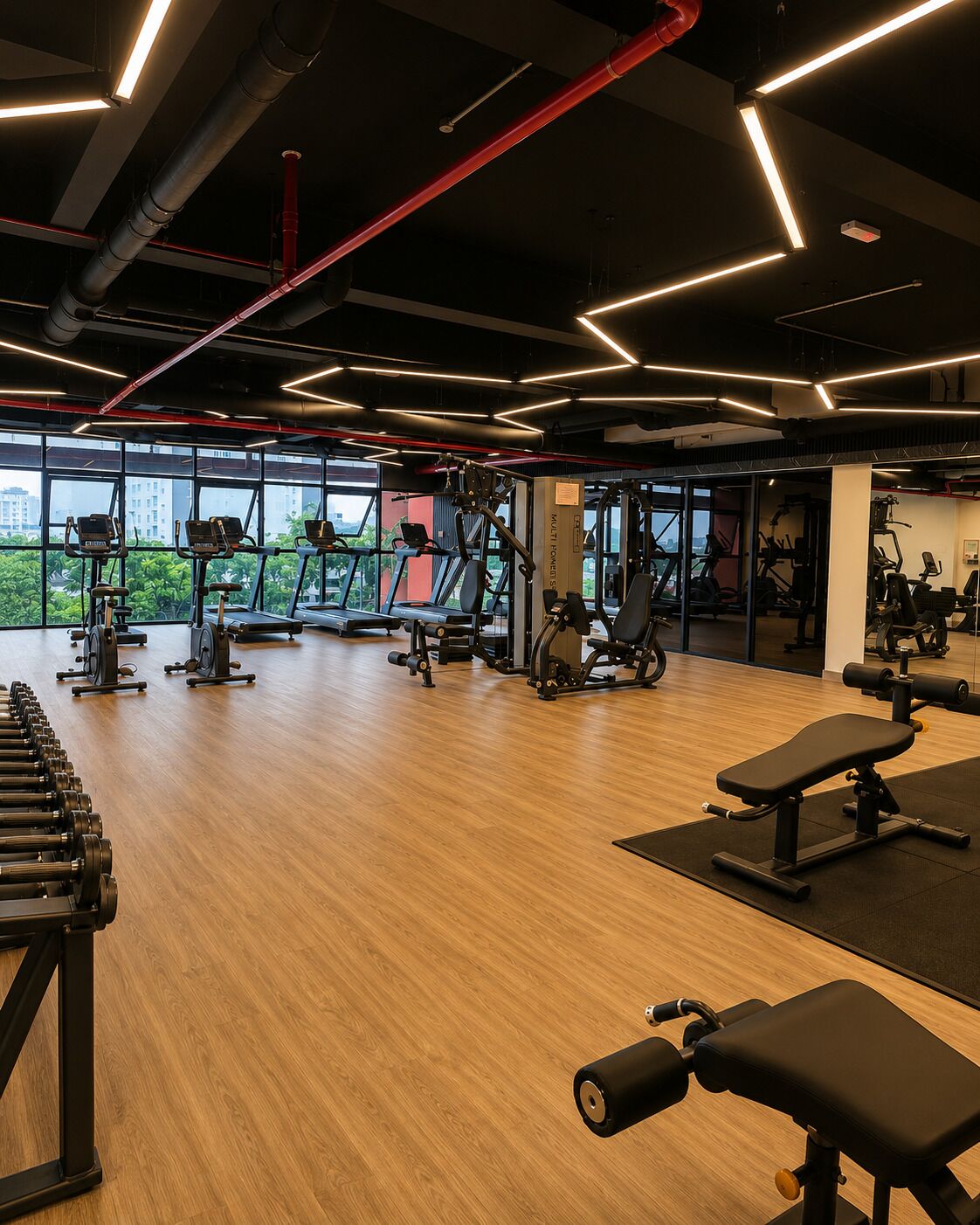 A gym with treadmills, elliptical machines, and free weights.