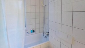 A bathroom with a bathtub, a shower, and a handrail. - Charming 3 Bedroom Retreat (Zürich)