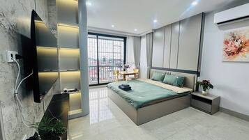 Deluxe Apartment, Balcony, City View | Desk, laptop workspace, blackout drapes, soundproofing