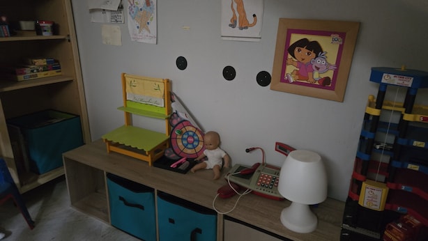 A child's play area with a desk, chair, storage bins, and educational toys. - APPARTEMENT DUPLEX RESIDENCE DU PARC (Saint-Nectaire)