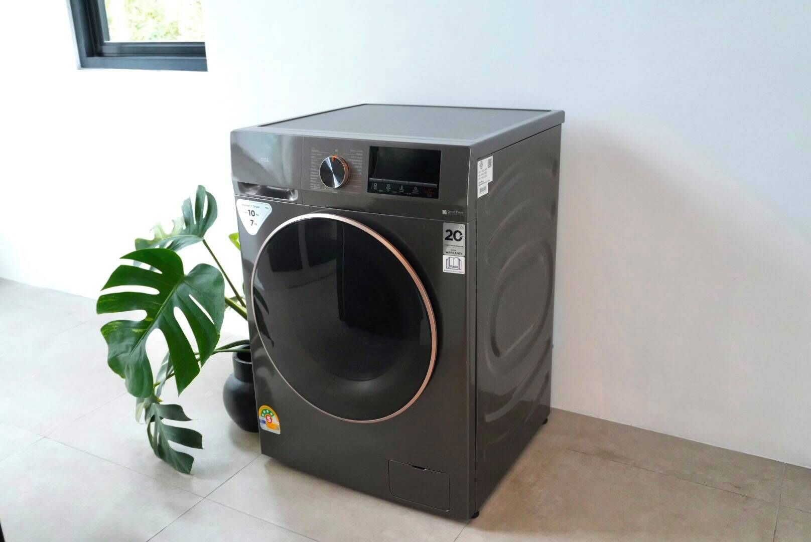A compact, gray front-loading washing machine with a digital display, a control panel, and a 2C rating sticker.