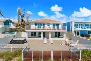 A two-story house with a pool, outdoor seating, and a hot tub. - 755 S Atlantic Ave (Cocoa Beach)