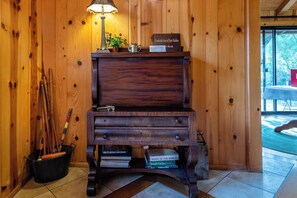 A wooden desk with a lamp, a book titled 'Creekside Inn of Paso Robles First Book,' and a potted plant. - Private Patio + Kitchenette + Dining | Vineyards + Coast Nearby | Creekside Room (Paso Robles)