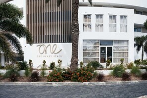 A modern building with a sign reading 'ONE MAMBO BEACH' and 'BOCOBAY' indicating a hotel or resort. - LUX 2BD/2Bath Condo - ONE Mambo Beach 1 by Bocobay (Willemstad)