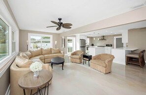 A spacious living area with a sofa set, a coffee table, and a dining table. - Private Retreat • Pool • Jacuzzi • Mini Golf (Pinellas County)