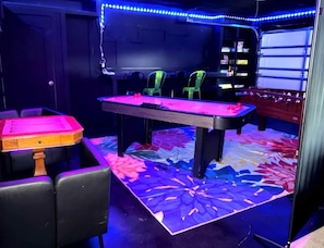 A room with a pool table, green chairs, and a foosball table. - Heated Pool • Jacuzzi-Fire Pit - Mini Golf - Game (Pinellas County)
