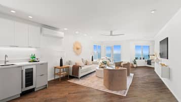 A spacious living area with a kitchen, a dining area, and a seating space with a view.