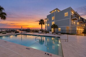 A hotel with a pool, a sunset view, and a pier with boats. - Three-Story Home | Boat Slip | Walk Downtown (Saint Augustine)