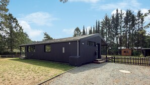 A modern, single-story building with a dark exterior, large windows, and a covered porch area. - 3 bedroom amazing home in Ebeltoft (Ebeltoft)