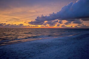 A beach with a sunset and ocean waves. - On the Beach Condo for the Ultimate in Relaxation (Bonita Springs)