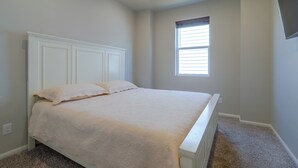 A bedroom with a single bed, a window with blinds, and a ceiling light. - Private Yard w/ Patio! Modern Commerce City Gem (Commerce City)