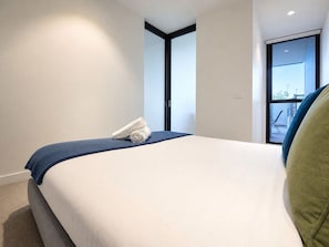 Ein Hotelzimmer mit einem Bett, einem Fenster und Blick ins Freie.