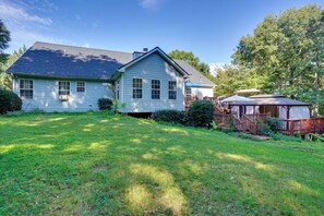 A two-story house with a front yard and a wooden deck. - Hot Tub & Deck! Loganville Group Retreat (Loganville)