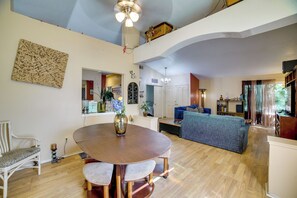 A spacious living area with a dining table, a sofa, and a ceiling fan. - Near Golf & Buzzers Baseball! Ontario Ranch Home (Ontario)