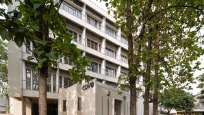 A multi-story building with a flat facade, a visible entrance, and a sign that reads 'cove'. - Cove Svasa (Jakarta)