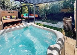 A backyard with a hot tub, wooden deck, and outdoor seating area. - 1 bedroom accommodation in Raywell, Beverley (Raywell, Beverley)