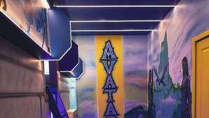 A hallway with a wooden floor, a staircase, and a wall with a mountain landscape mural. - Luxury Disney Manson - Newly renovated - Sleeps 30+ - Book today (Kissimmee)
