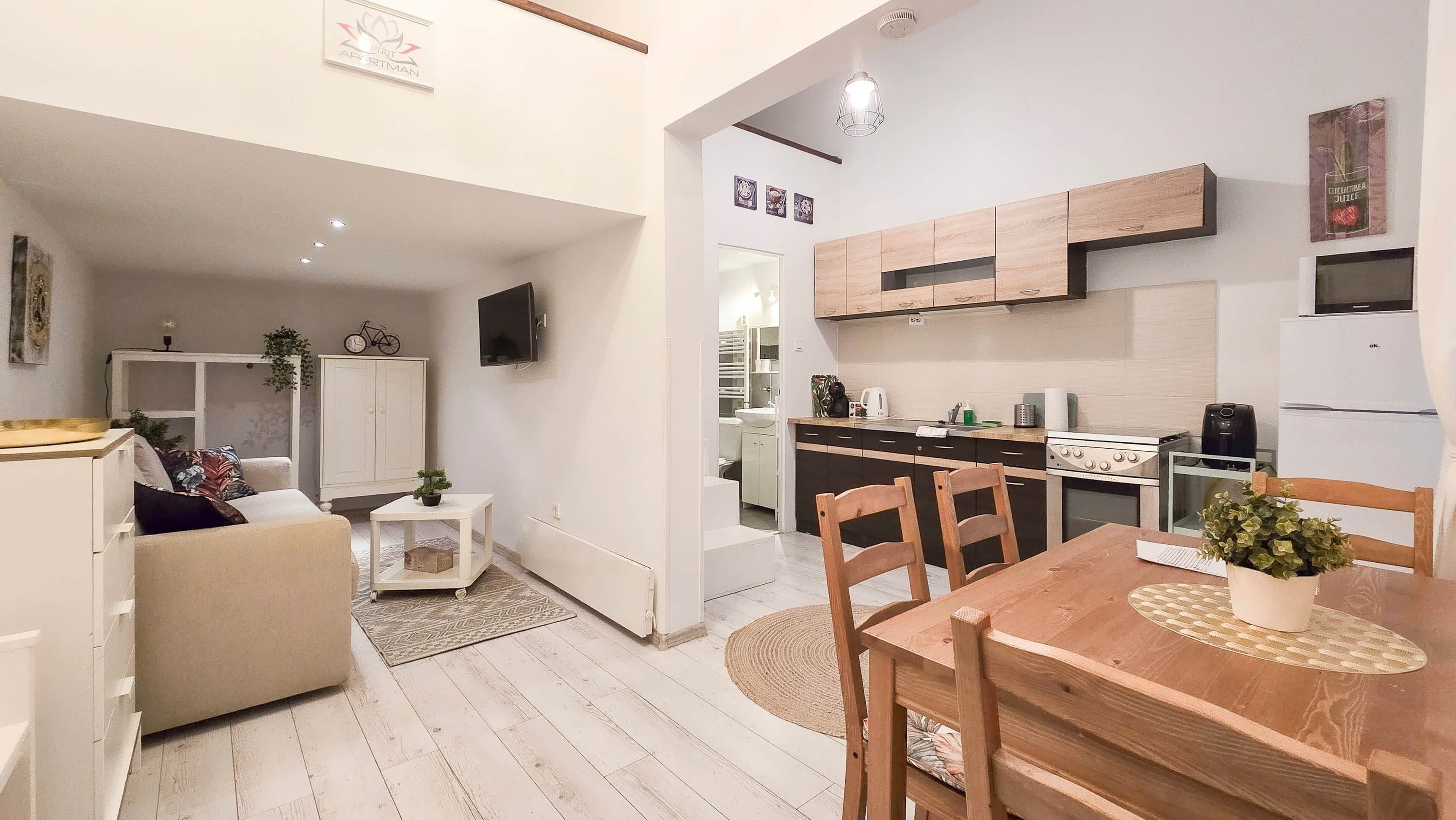A compact living space with a kitchenette, a dining area, and a seating area.