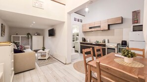 A compact living space with a kitchenette, a dining area, and a seating area. - IMCT - MSpirit Apartman B Budapest (Budapest)