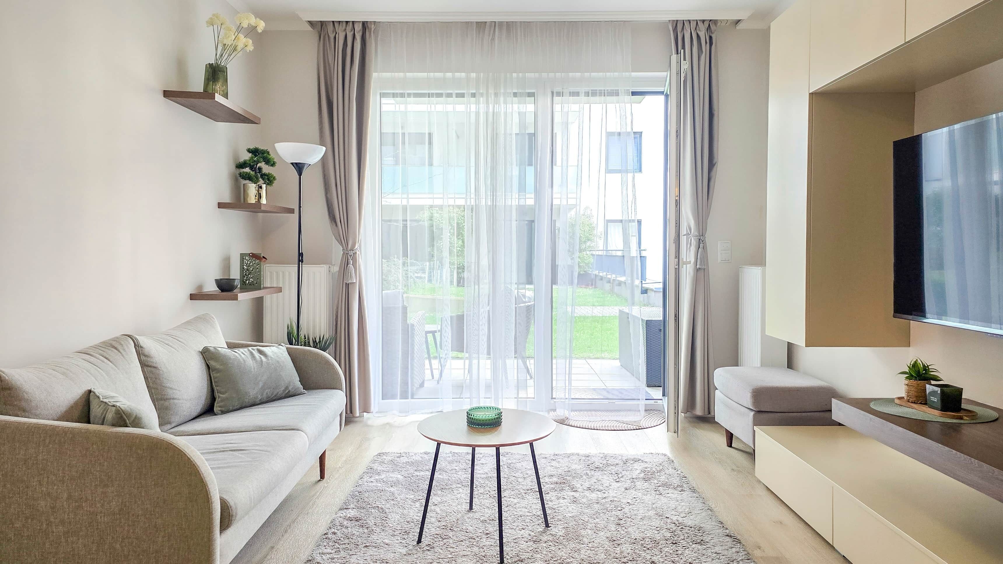 A modern living room with a sofa, coffee table, and TV.