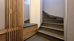A wooden bench with a backrest and a staircase with a handrail. - IMCT - Rooftop Serenity Apartment (Budapest)