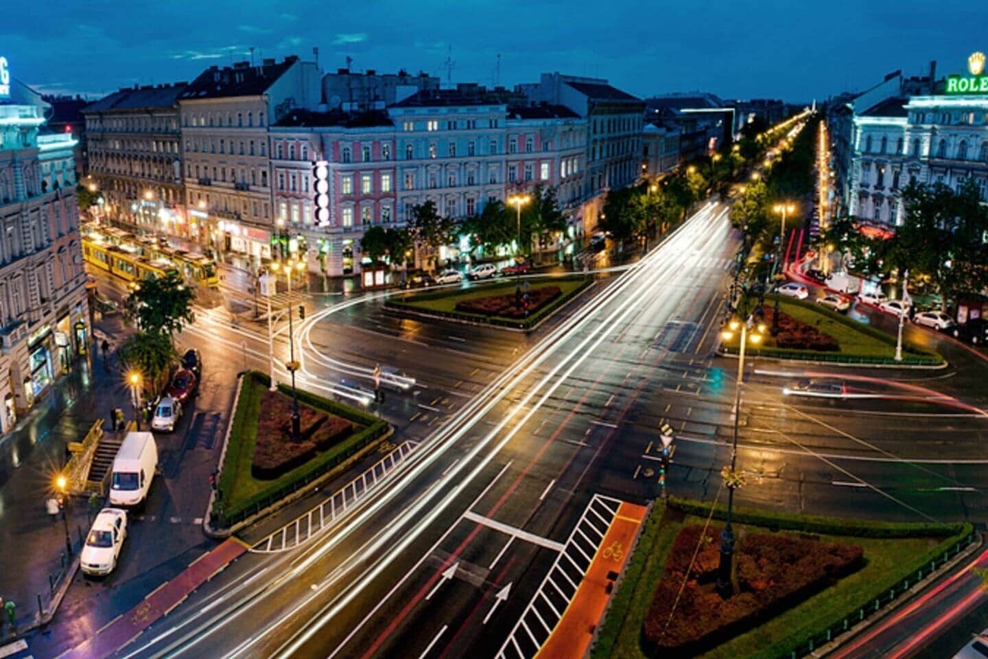 A city intersection with multiple lanes, traffic lights, and a roundabout.