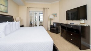A hotel room with a large bed, a desk with drawers, a chair, a television, and a window with curtains. - The Oasis 1604 Formerly Phoenix West Ii 1604 3 Bedroom Condo (Orange Beach)