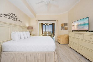 A hotel room with a large bed, a television, a desk, and a chair. - The Oasis 2608 Formerly Phoenix West Ii 2608 3 Bedroom Condo (Orange Beach)