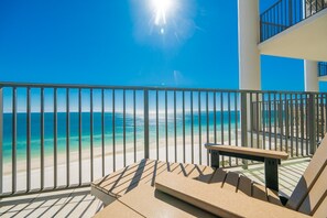 A balcony with a view of the ocean, a bench, and a railing. - The Oasis 1205 Formerly Phoenix West Ii 1205 3 Bedroom Condo (Orange Beach)