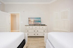 A hotel room with two beds, a dresser, and a painting of a beach scene. - The Oasis 1205 Formerly Phoenix West Ii 1205 3 Bedroom Condo (Orange Beach)