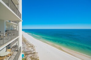 Ein Strandhotel mit Pool, Balkonen und freiem Blick auf das Meer.