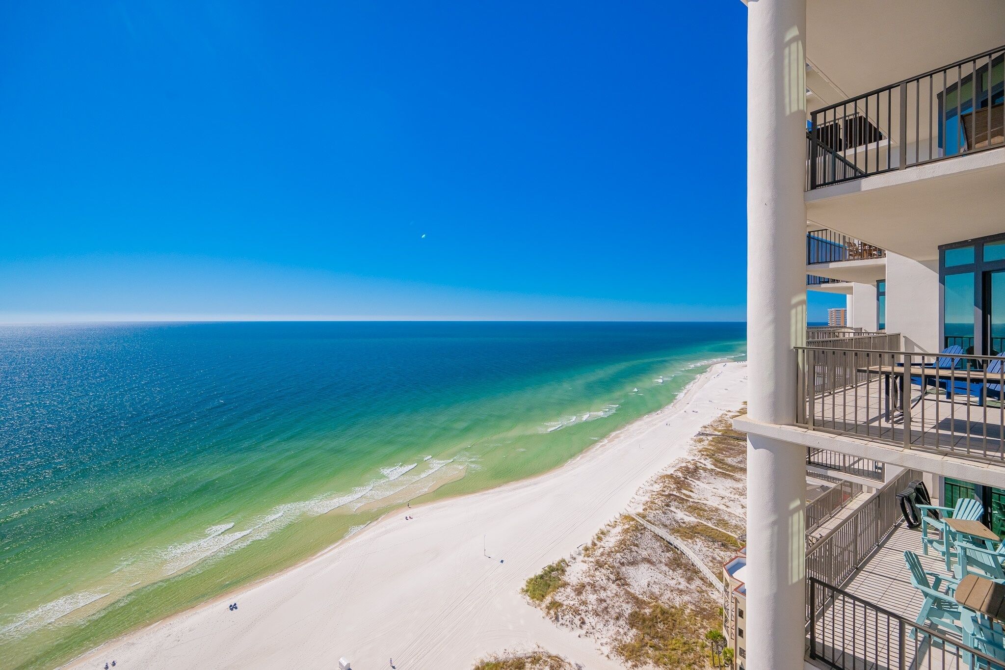 A beachfront hotel with balconies overlooking the ocean.