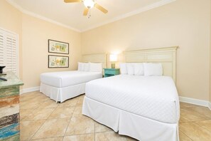 A hotel room with two beds, a ceiling fan, and artwork on the walls. - The Oasis 404 Formerly Phoenix West Ii 404 3 Bedroom Condo (Orange Beach)