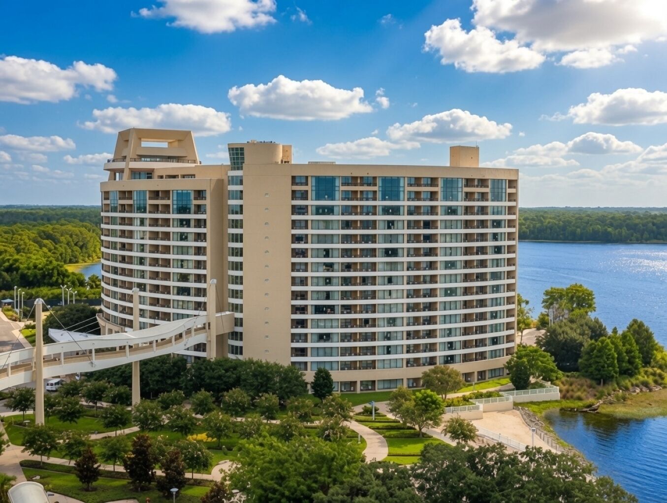 A multi-story hotel with a central courtyard and a lake view.