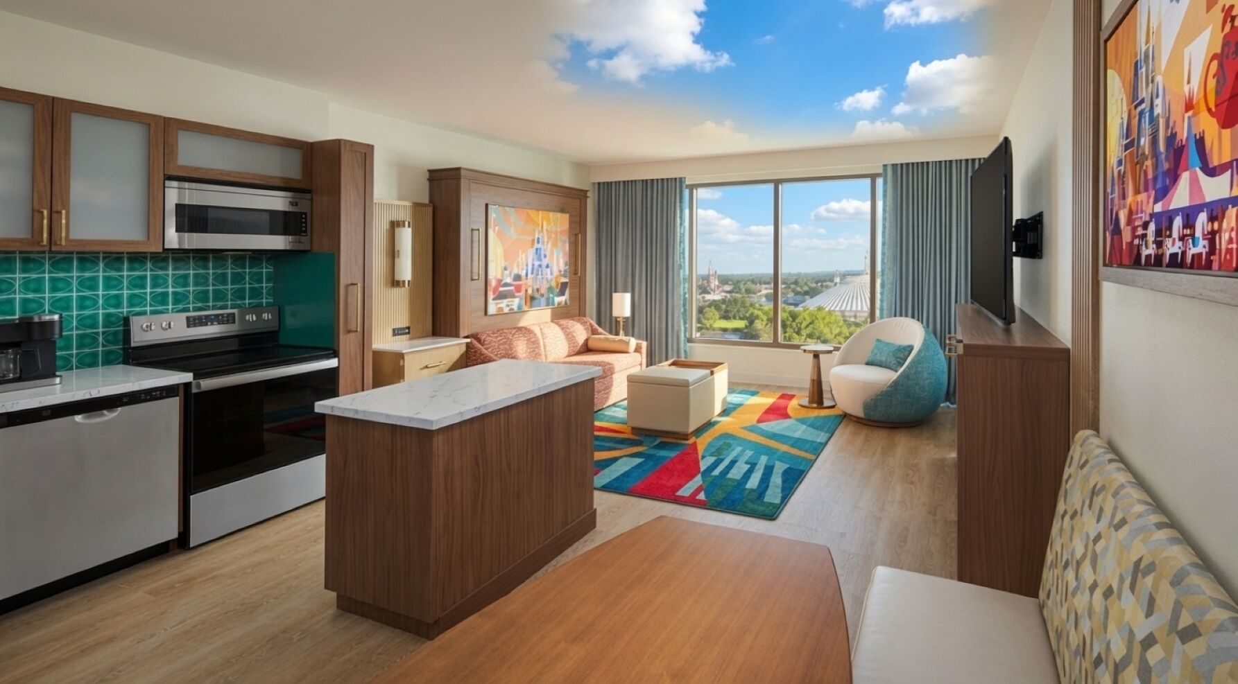 A modern kitchen with a central island, a dining area with a colorful rug, and a living space with a sofa and a view of the city.