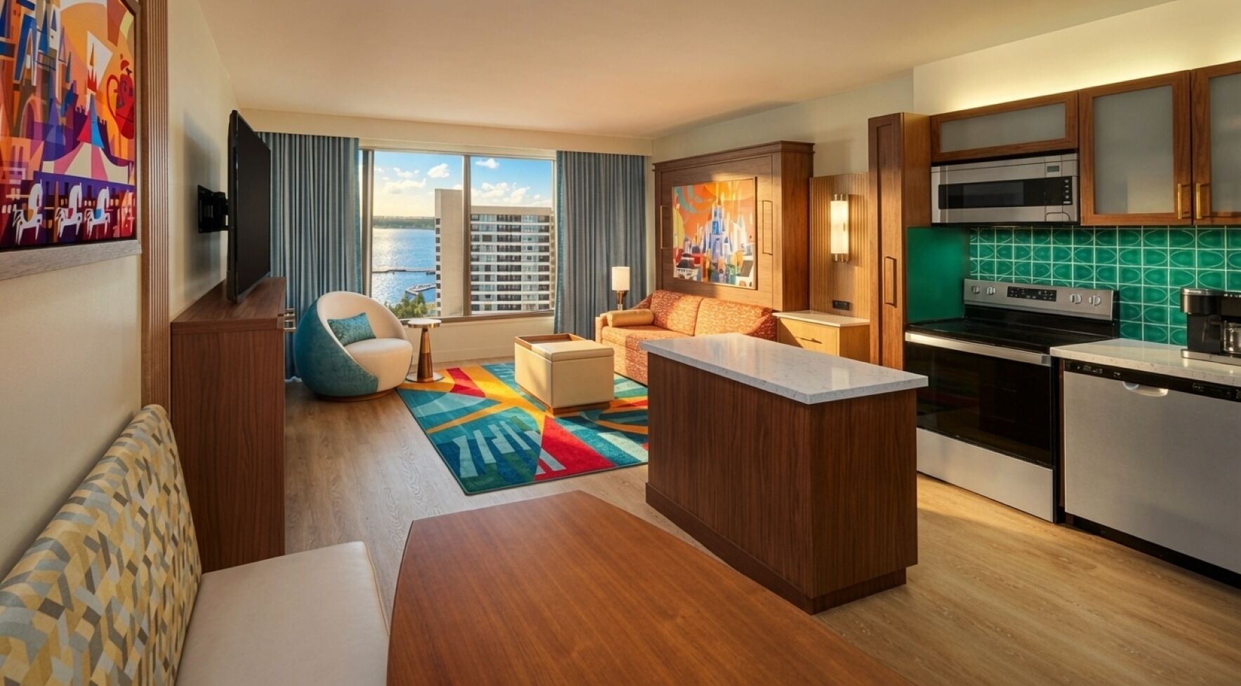 Een moderne hotelkamer met een keuken, een eethoek en een zithoek.