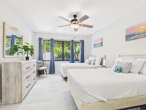 A bedroom with a bed, a desk, a chair, a ceiling fan, and a window with curtains. - SoulShine is oceanfront with beautiful sunrises and sunsets in St. Croix! (Christiansted)
