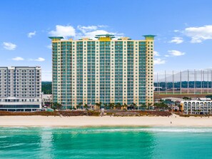 A high-rise hotel with multiple balconies, located near a beach. - Gulf-Front Condo with Balcony Access from the Primary Suite + Steps to Pier Park (Panama City Beach)