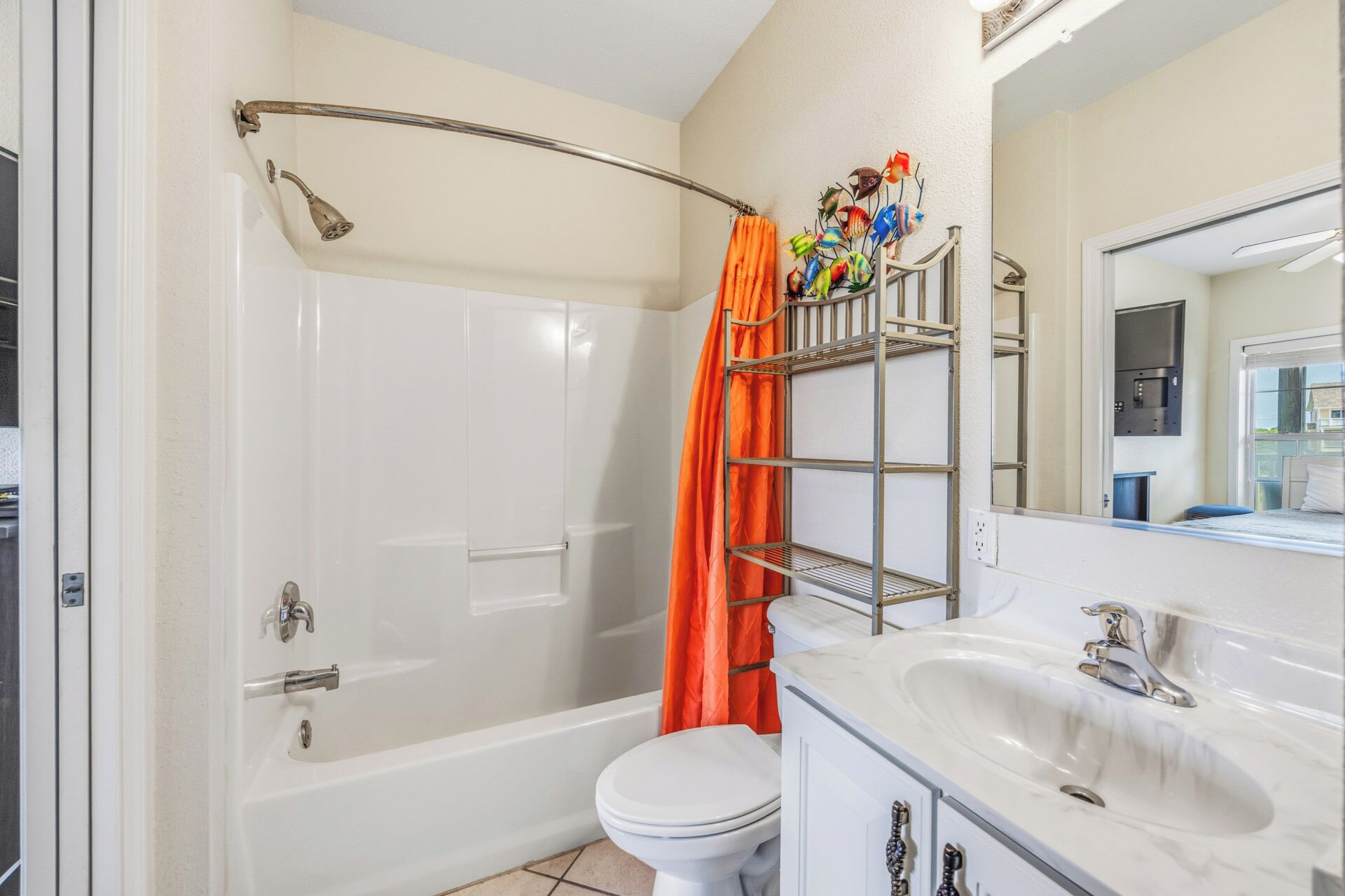 A bathroom with a bathtub, toilet, and a vanity with a sink.