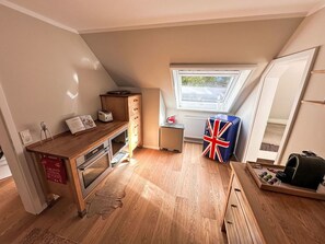 A compact kitchen with a wooden countertop, a built-in oven, a window with a view, and a flag on the wall. - Cosy apartment for 5 people with TV and patio (Ringstedt)