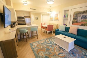 A compact living space with a kitchenette, a dining area, and a seating area with a sofa and chairs. - Orlando | Relaxed Group Resort Stay | Pool + Walkable BoardWalk | 2BR Lock-Off (Lake Buena Vista)
