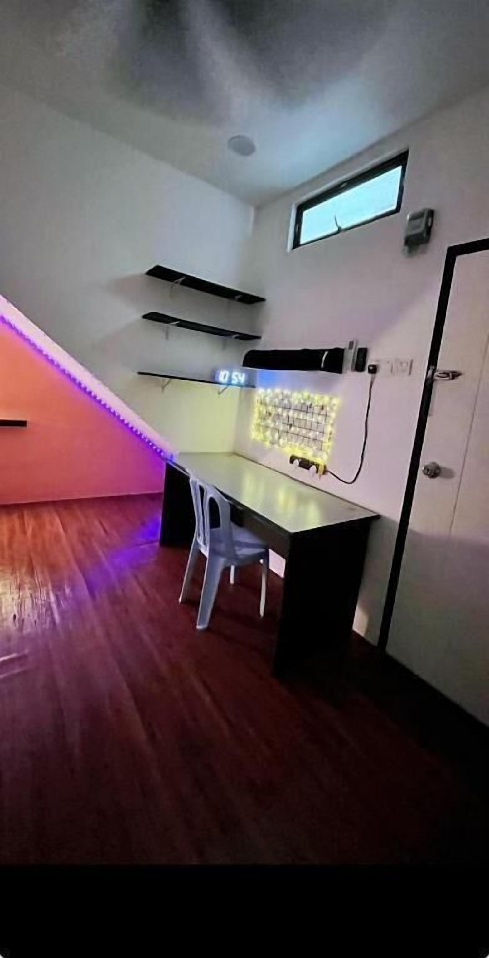 A room with a desk, chair, and a window.
