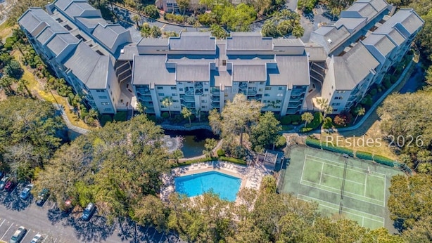A multi-story hotel with a swimming pool and tennis court. - Serene Villa Steps From Beach w/ Pool and Tennis! (Hilton Head Island)