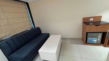 Suite familiar, balcón, vistas a la colina | Zona de estar | Smart TV de 21 pulgadas con canales por cable