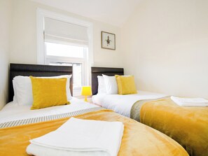 A hotel room with two beds, a window with blinds, a lamp, and a framed picture on the wall. - 46 Ashville Avenue (Scarborough)