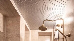 A bathroom with a freestanding sink, a toilet, and a shower with a handheld showerhead. - Ve Hotels (Sanliurfa)