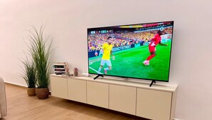 A television on a white entertainment unit with a sports game displayed. - Sea View & Pool, Elite Resort (Saranda)