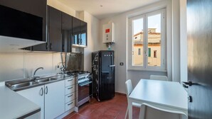 Private kitchen - An elegant 75 sqm apartment, ideal for 4 people, located on the 6th and top floor of a building with an elevator (NOT accessible to people with disabilities).The Lodi metro station is just a 4-minute walk away, making it easy to get around the capital. (Rome)