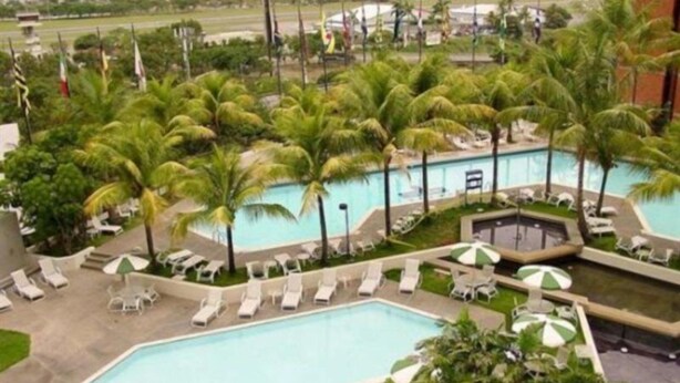 A swimming pool with multiple lounge areas and palm trees. - Eurobuilding Hotel and Suites Caracas (Caracas)